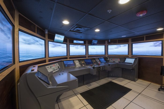 ship control room simulator with screens and panel of buttons and controls